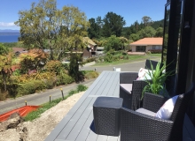 Sunny deck off kitchen/lounge area offers views over Lake Taupo